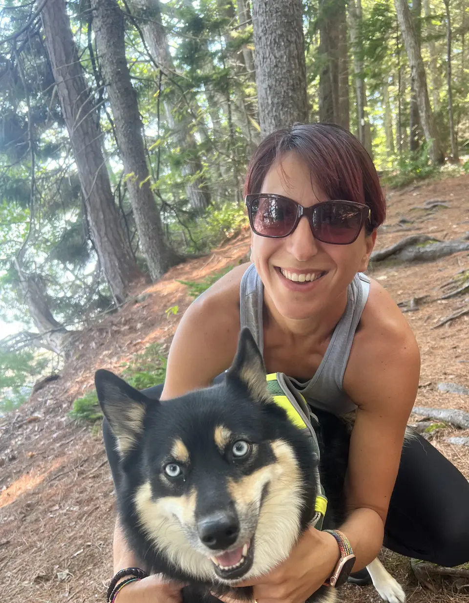 Manuela, founder and owner of Dogtown, with her dog Kiara on a forest trail