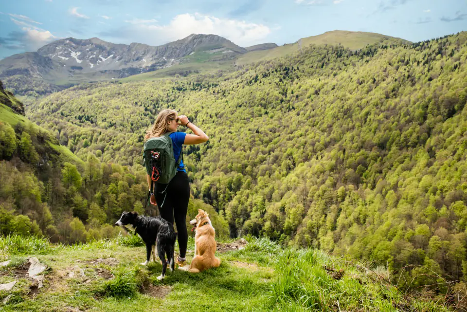 Young woman in sportswear doing a breack during a hike near
